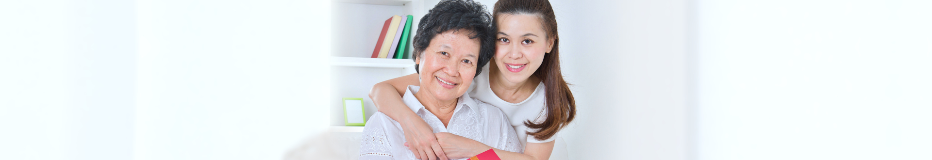 caregiver hugging senior woman